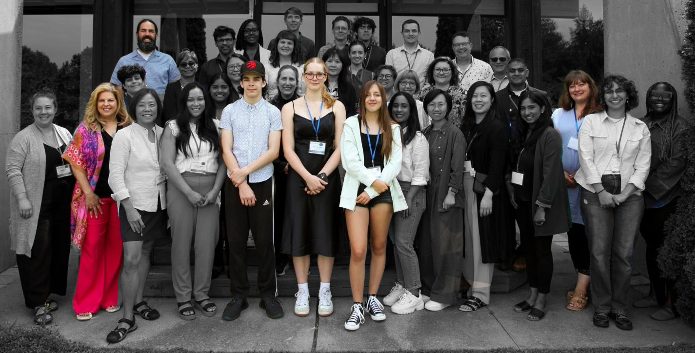 CHILD participant family members pose with staff and researchers at a 2024 workshop